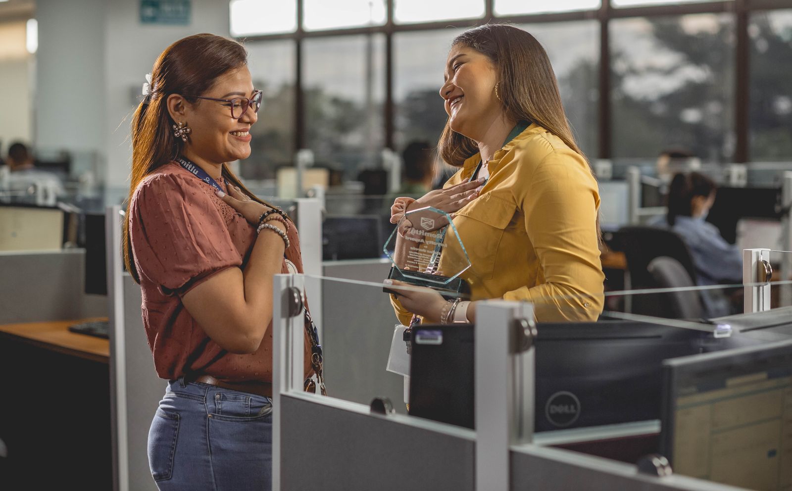 Two coworkers celebrating an award together